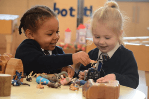 2 pupils playing with toys