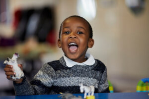 A young boy laughing.