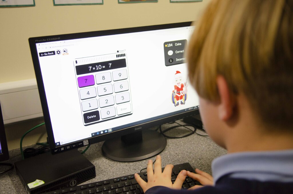 A boy using an online calculator on the computer.