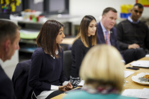 Teachers sitting around a table at a meeting.