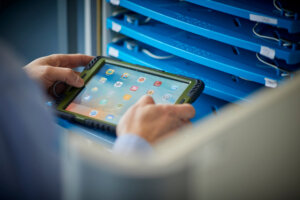 A pair of hands holding a computer tablet.