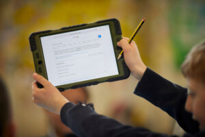 A young boy holding a tablet