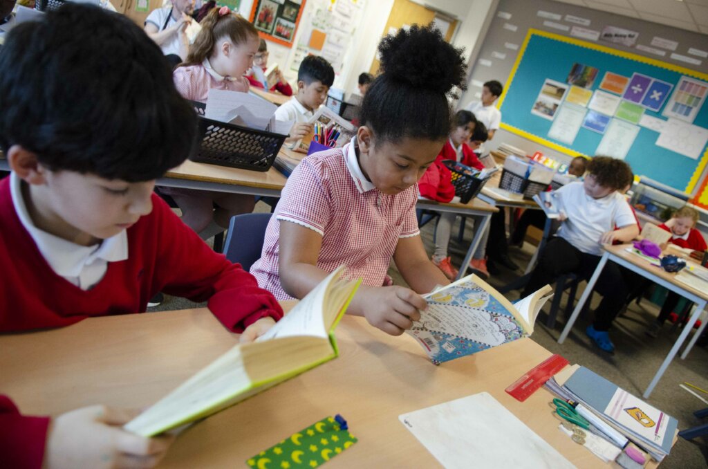 girl pupil reads from book