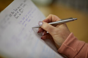 A woman writing in a notebook.