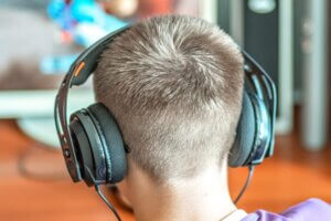 A teenage boy wearing headphones