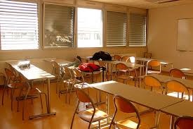 An empty classroom with empty desks.