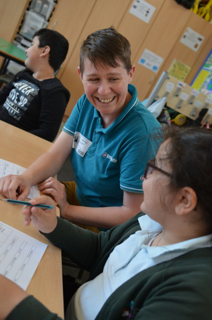 teacher with pupil going through work sheets