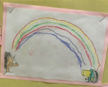 A child's drawing of a rainbow, with a hedgehog and a tortoise at either end.