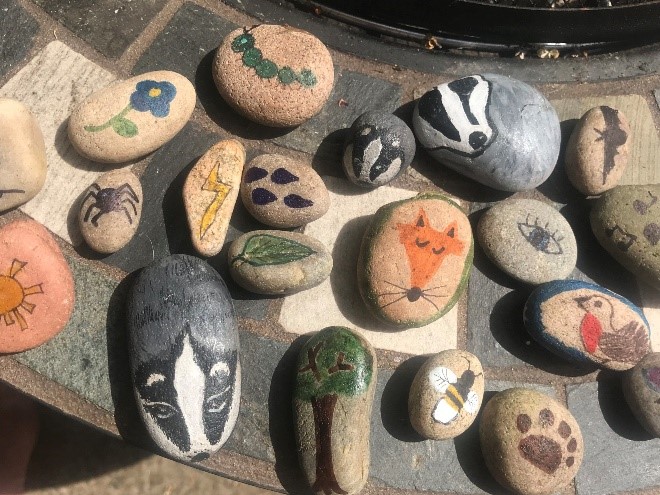 Animals, flowers and other natural symbols painted onto stones.