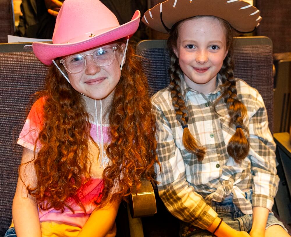 Two school children dressed in cowboy hats for the Big 'Country' Sing.