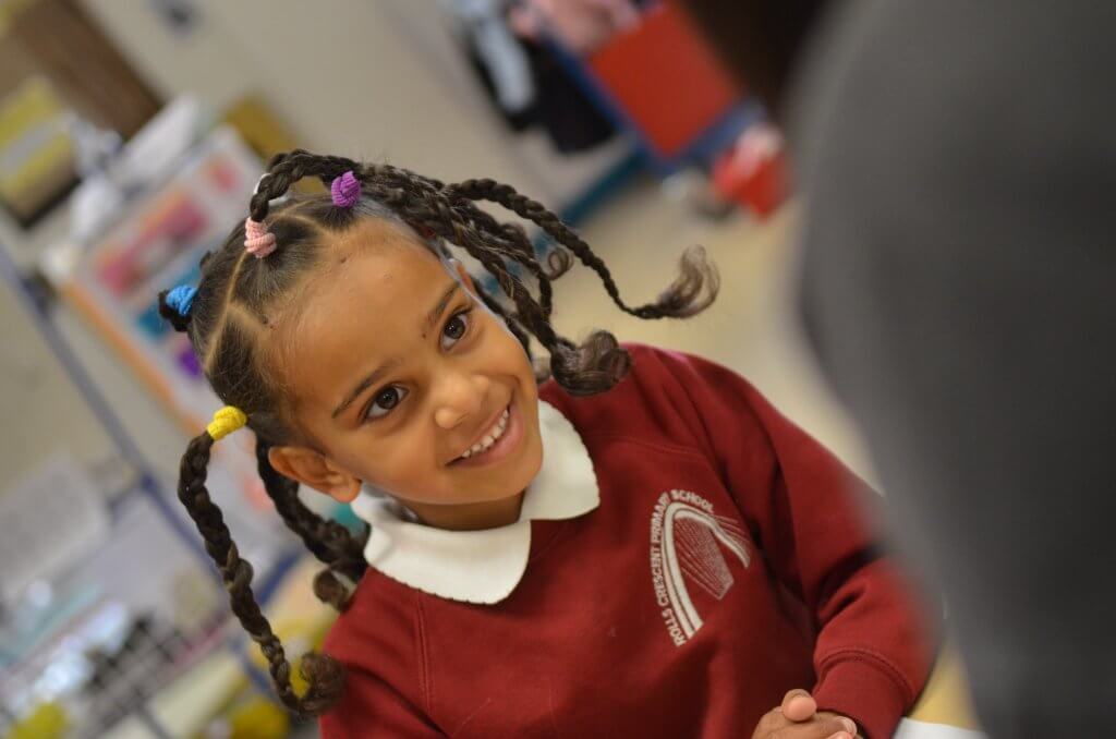 A school girl smiling.